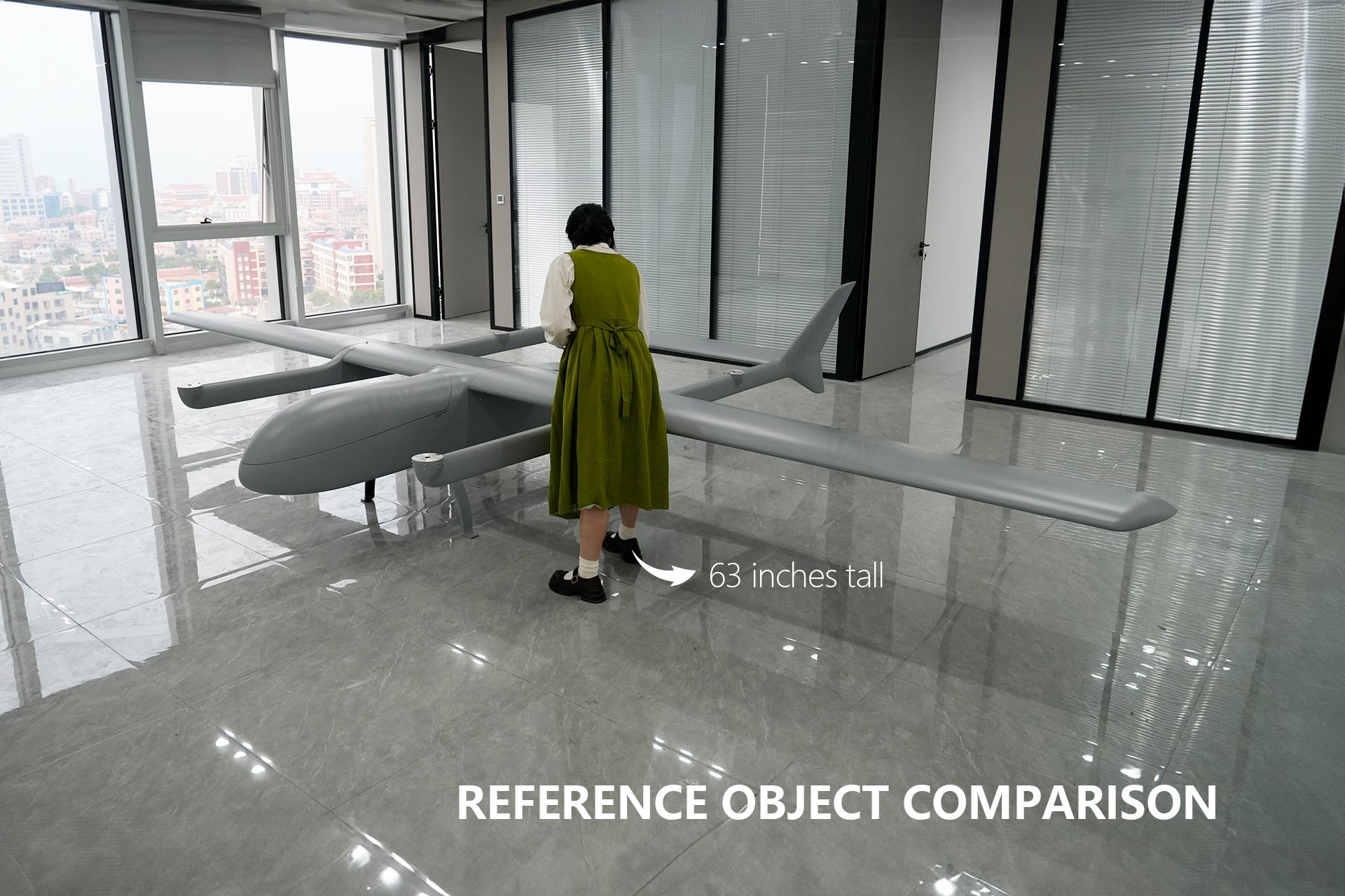 VTOL drone with 6000mm wingspan compared to a person indoors for scale.
